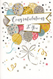 The photograph shows an elegant congratulations card that captures the feeling of a lively yet sophisticated celebration, much like a special evening shared in Colliers Wood. At the centre of the design, a cluster of balloons forms a floating bouquet, gathered loosely and drifting upward as if just released from someone's hand. The balloons are coloured in soft metallic gold and silver, creamy champagne, pastel sky blue, dusty pink, and calming grey. Each is decorated with its own pattern: some shimmer with tiny star shapes, others are ringed with narrow metallic stripes or sprinkled with glittery dots, suggesting reflected light and movement, like festive lights along London Road. From the bottoms of the balloons, slender ribbons trail down in graceful curls, rendered in gold and silver tones that twist and overlap, giving the sense of gentle motion. A billboard-like banner curves across the middle of the cluster, holding a stylish "Congratulations" message written in flowing script that feels both personal and refined. It's easy to imagine this card accompanying a bouquet for a promotion, graduation, or new chapter in life celebrated in and around Colliers Wood. The background of the card is a light, neutral shade, scattered with small metallic stars, swirls, and dots that resemble confetti tumbling lazily through the air after a toast. The composition is open and airy, with plenty of white space around the artwork so each detail can be appreciated. You can almost feel the smoothness of the card stock and the raised texture of the glitter, echoing the satisfying contrast of velvety petals and crisp foliage in a florist's arrangement. This congratulations card exudes happiness and pride with a subtle touch of glamour, ideal for marking milestones big or small.
